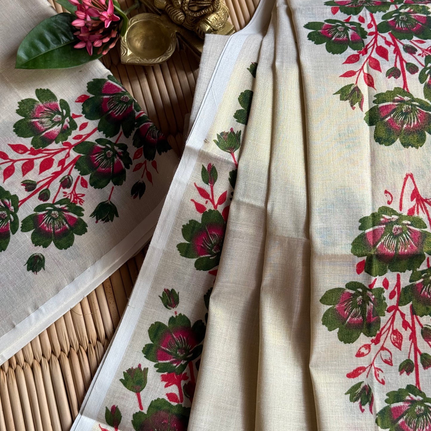 Floral patterned fabric with pink and green flowers on a beige background