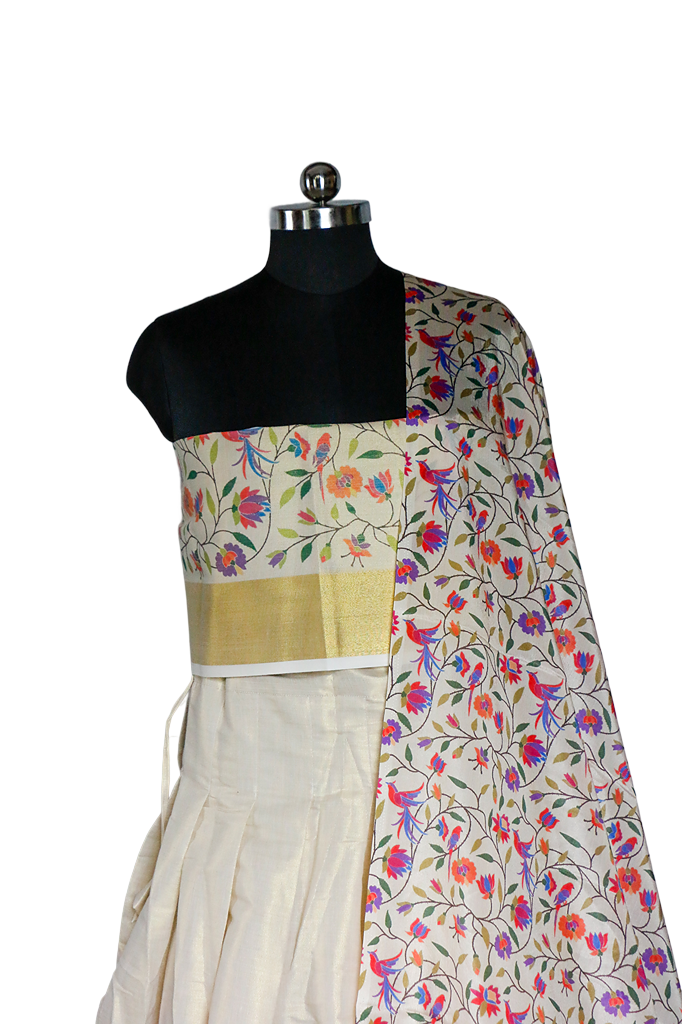 Mannequin wearing a floral saree with a gold border on a white background