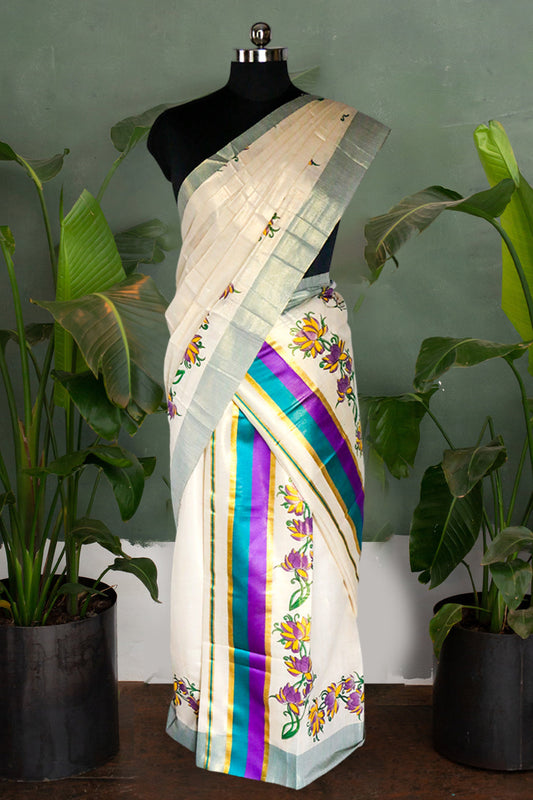 Saree with colorful patterns on a mannequin against a green wall with plants.