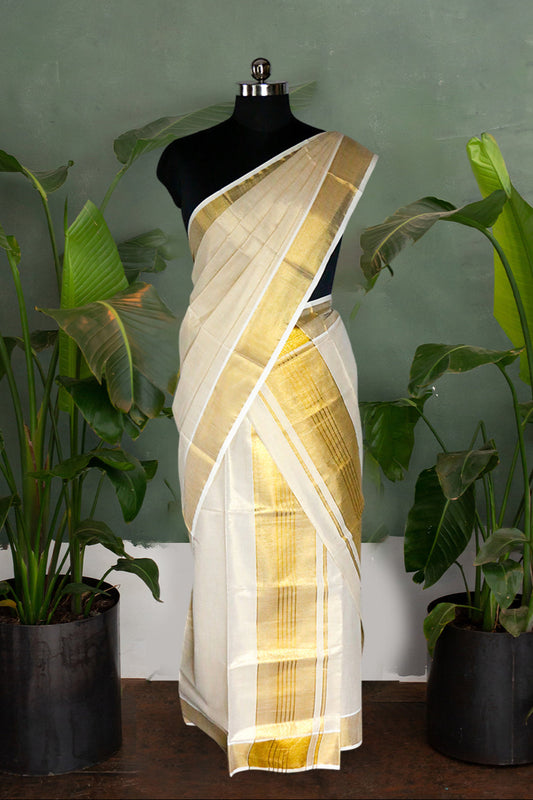 Mannequin wearing a white and gold saree with plants in the background