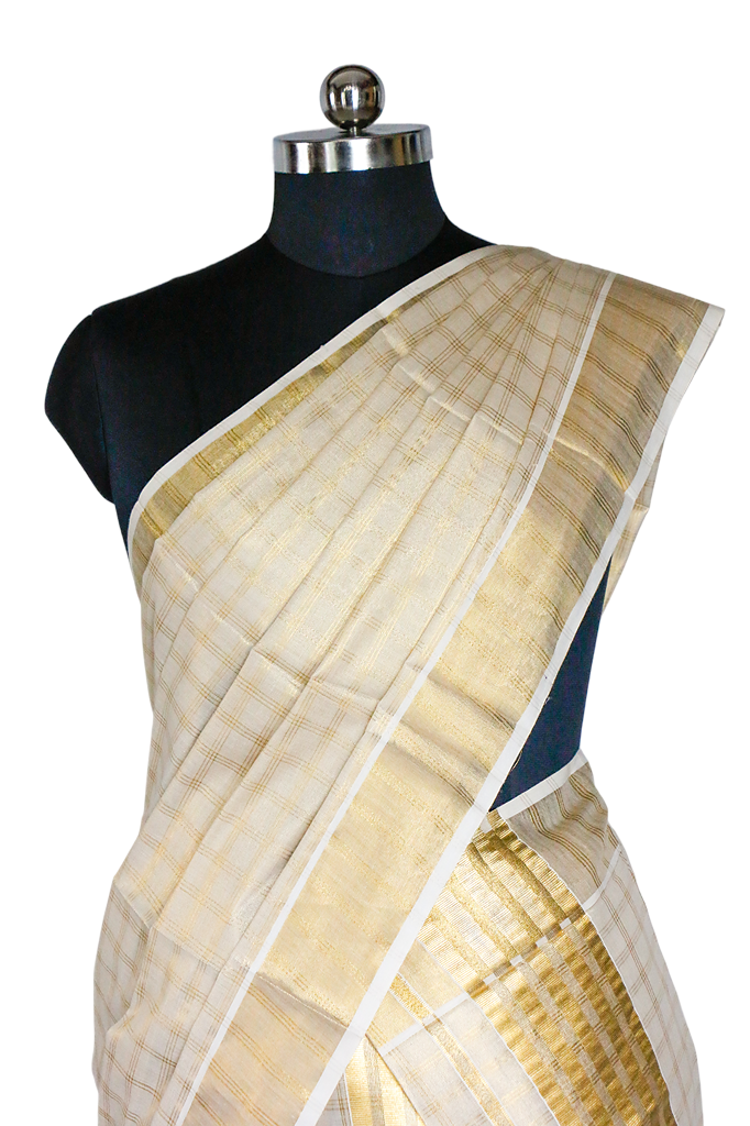 White saree with gold patterns on a mannequin against a white background